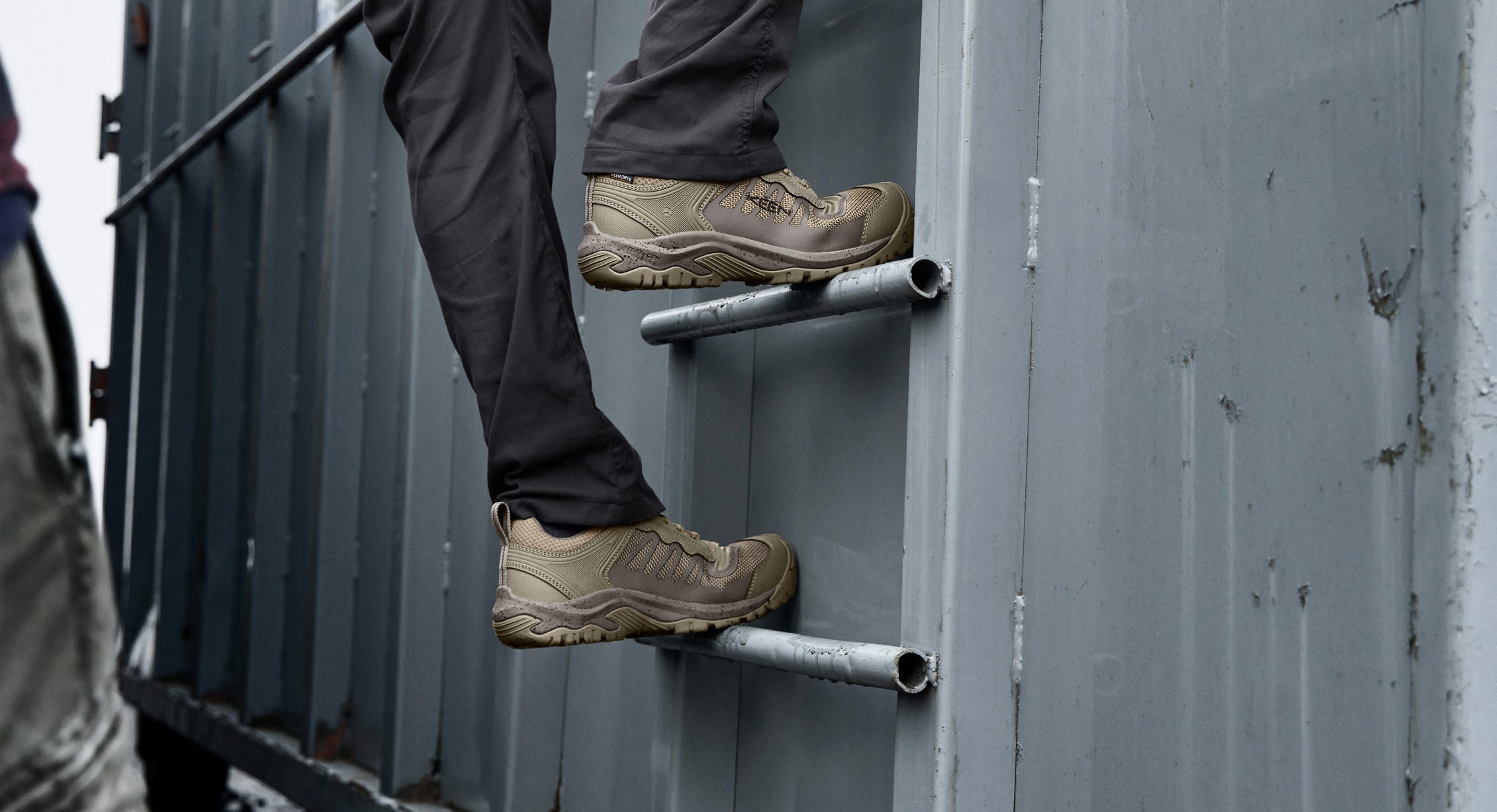 Worker climbing shipping container ladder in Reno shoe