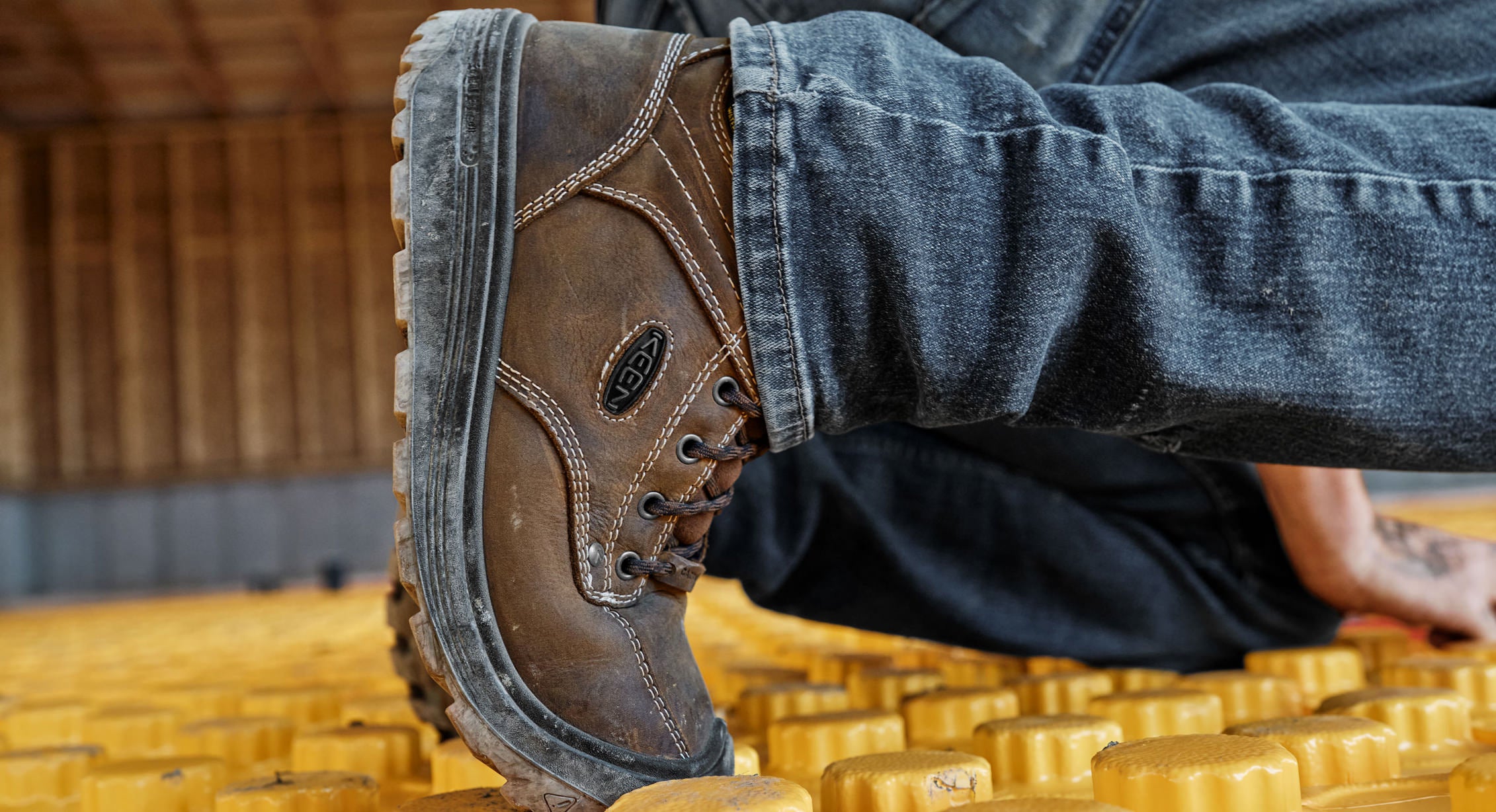 Worker kneeling in Fort Wayne Boots showing flex in toe box.