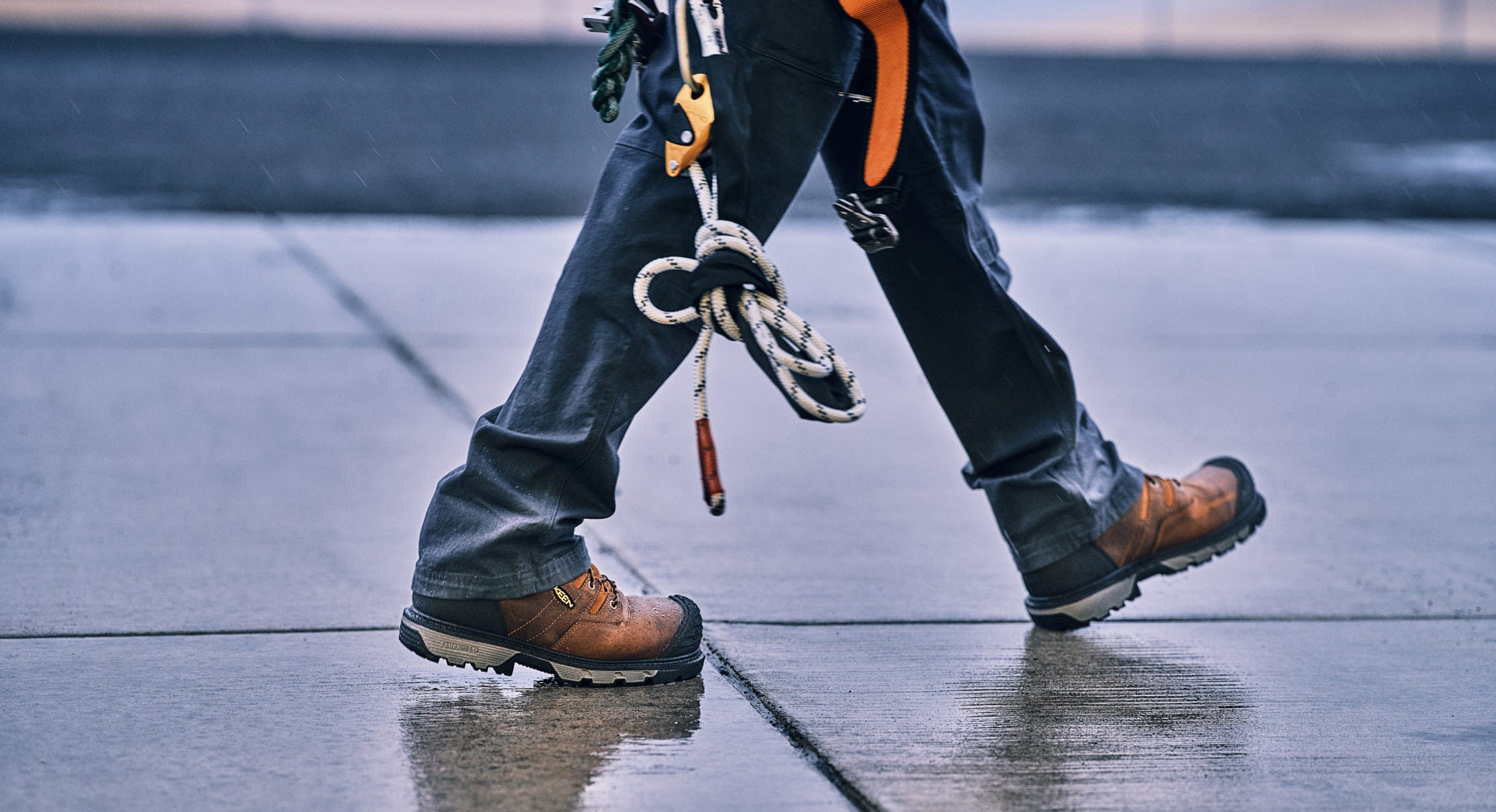 Person walking in Camden work boot on wet concrete