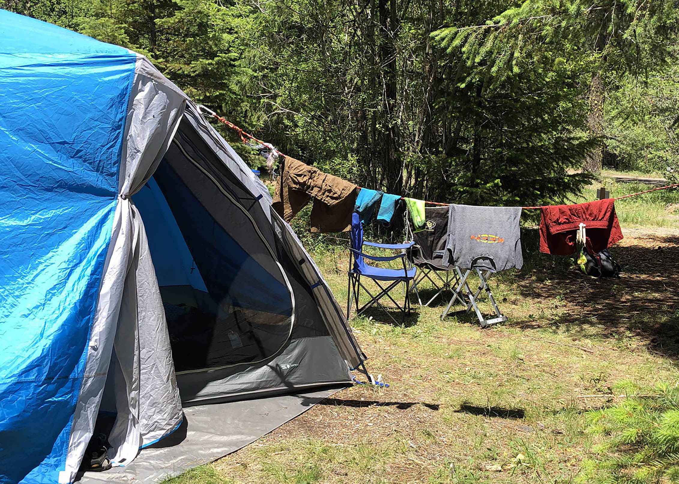 a tent with clothes on a line drying