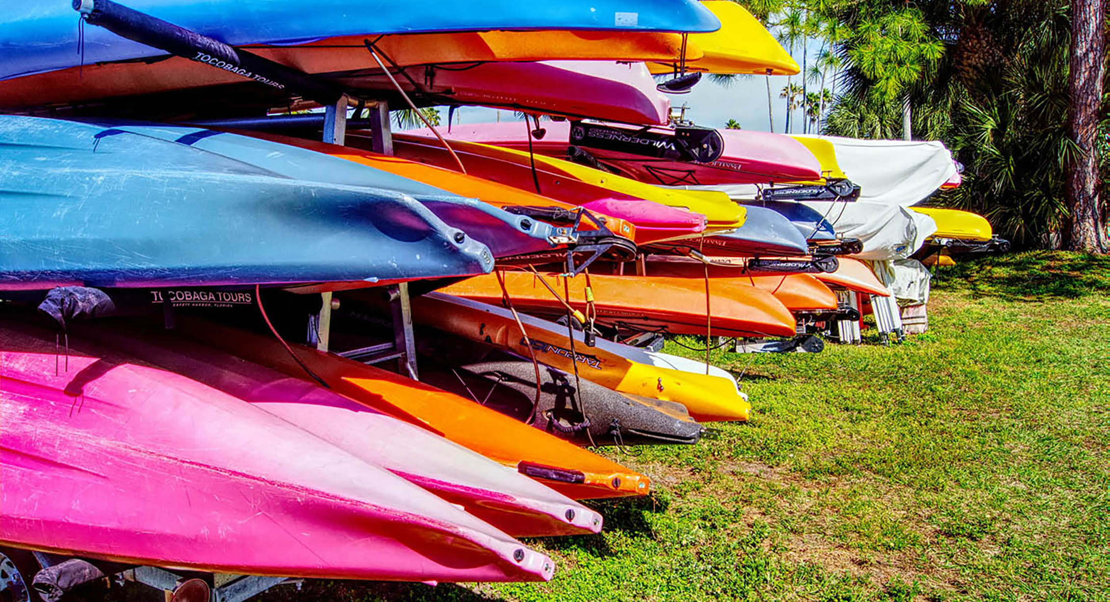 colorful kayaks waiting out of the water