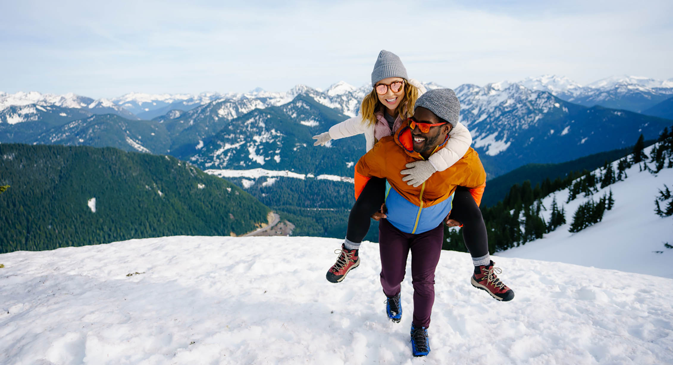 A man and a woman playing in the snow