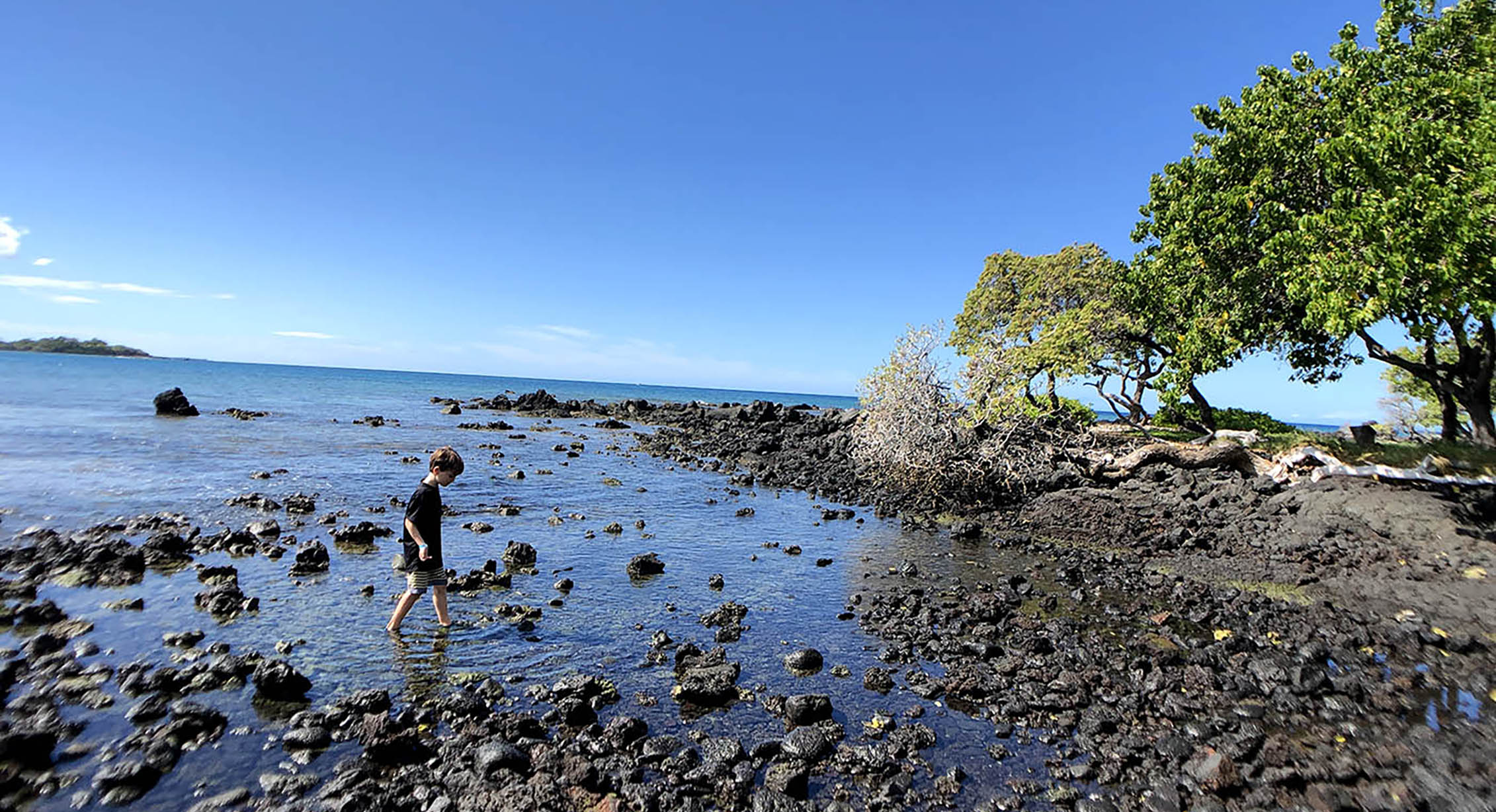 Navigating rocky beaches in Hawaii in KEEN water sandals