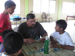 Jason teaching boys how to make a balsa wood airplane