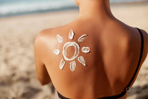 sunscreen in sunshine shape on woman's back