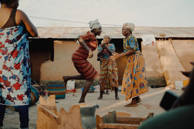Ghana weavers women dancing outside