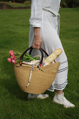 girl on the grass with Sophia Frances basket