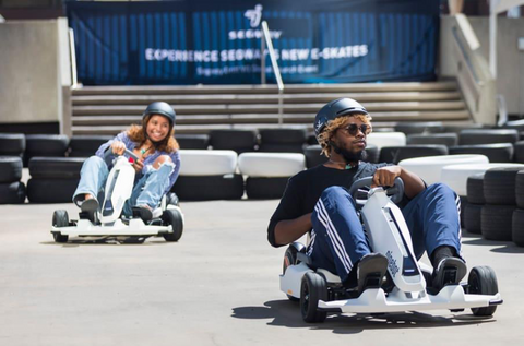 Girl and guy riding a Segway-Ninebot Gokart Kit