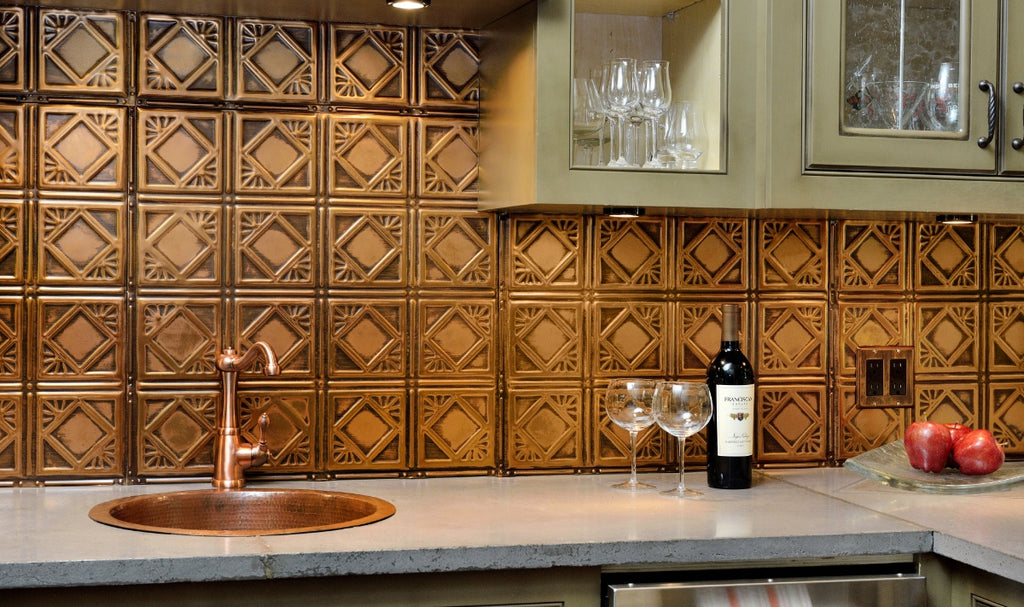 Copper tin tile backsplash in a small kitchen with sage cabinets and copper sink.