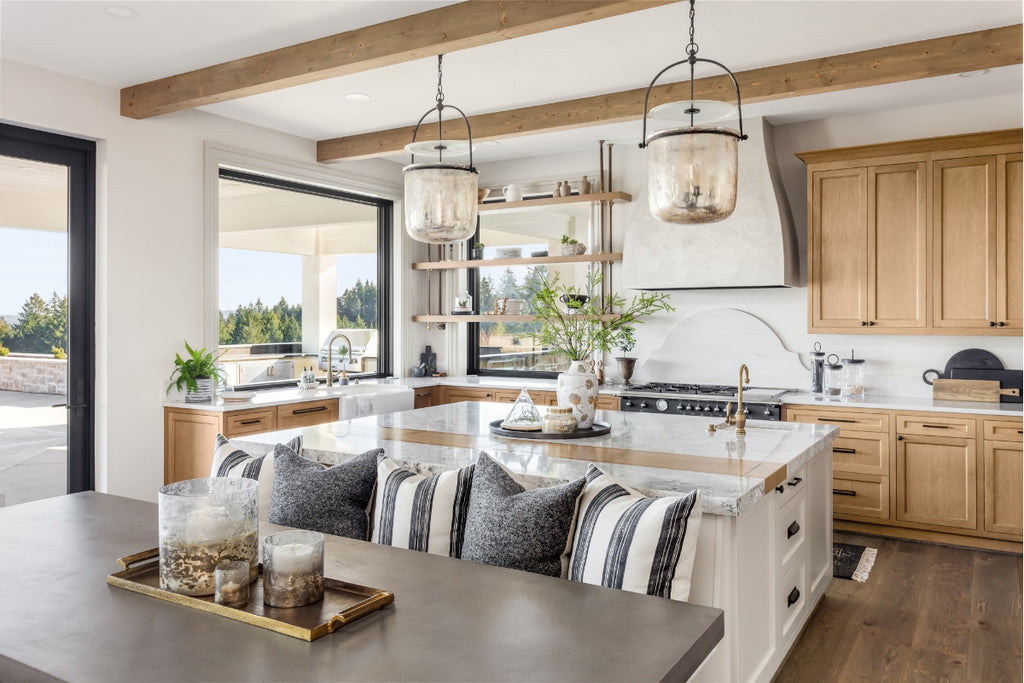 Cozy kitchen with light wood exposed beams and pendant lights.