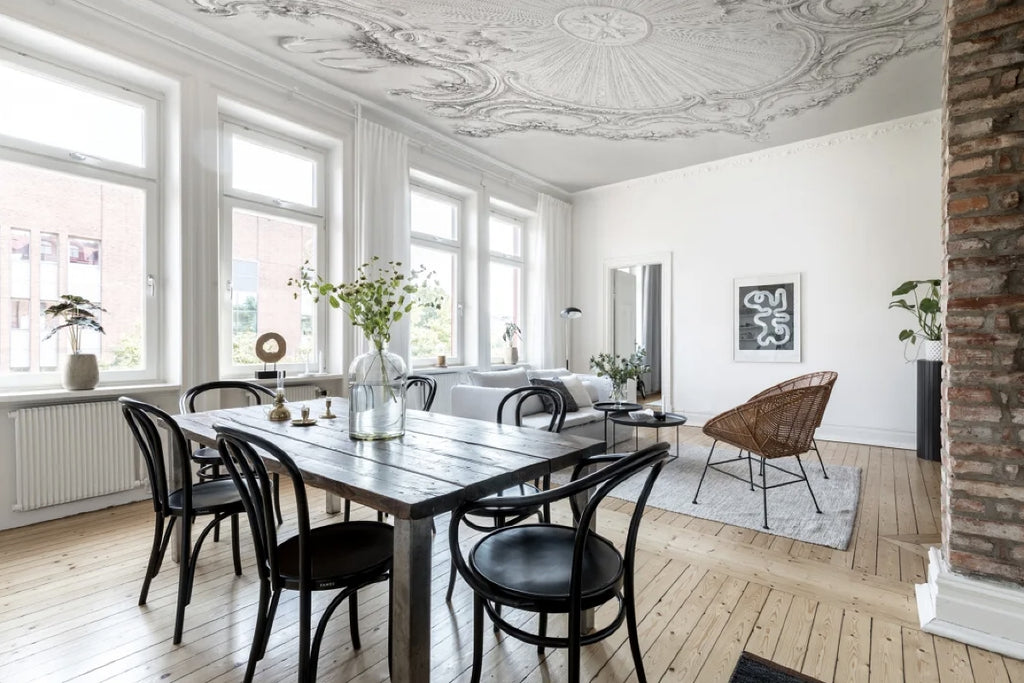 Cozy kitchen diner with dramatic wallpaper on the ceiling.