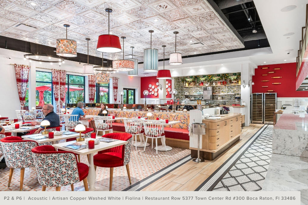 View of the dining room at Fiolina restaurant with acoustic tin tile on the ceiling in two different patterns.