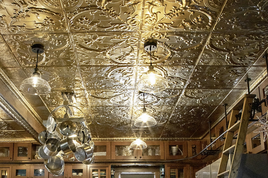 The Henry's kitchen area featuring American Tin Ceilings tiles in Pattern 9 and finished in Metallic Gold.