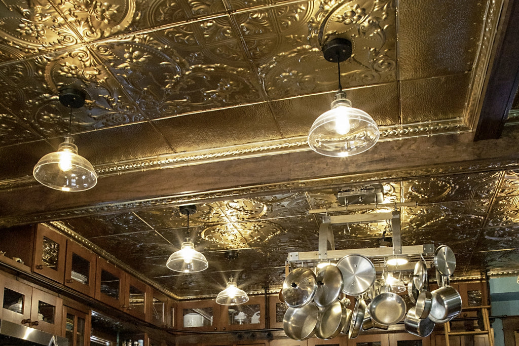 The Henry's kitchen area featuring American Tin Ceilings tiles in Pattern 9 and finished in Metallic Gold 