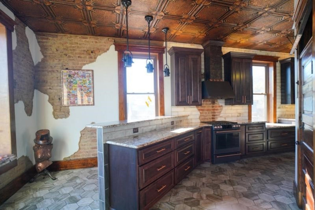 Reimagined kitchen with rustic elements and tin panels on the ceiling.