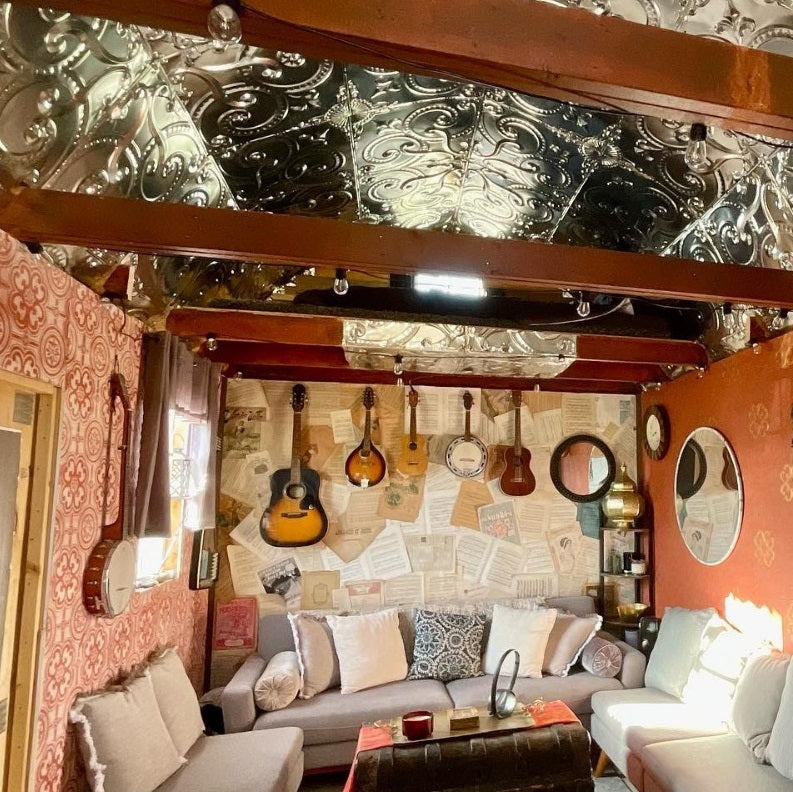 Barn-style shed remade into a tiny house with a barn tin ceiling.