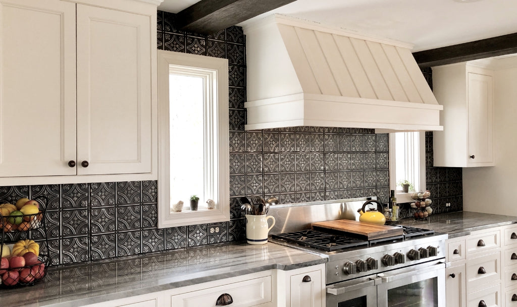 Tin tile backsplash in a black and white kitchen.
