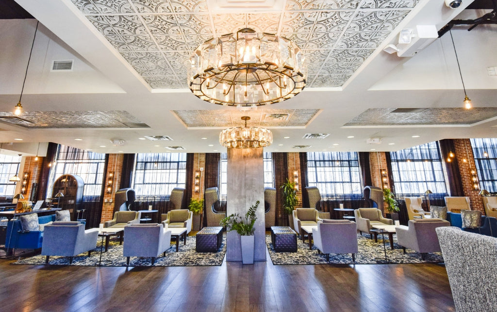 Large chandeliers highlight tin tile on the ceiling of the Foundry Hotel lobby.