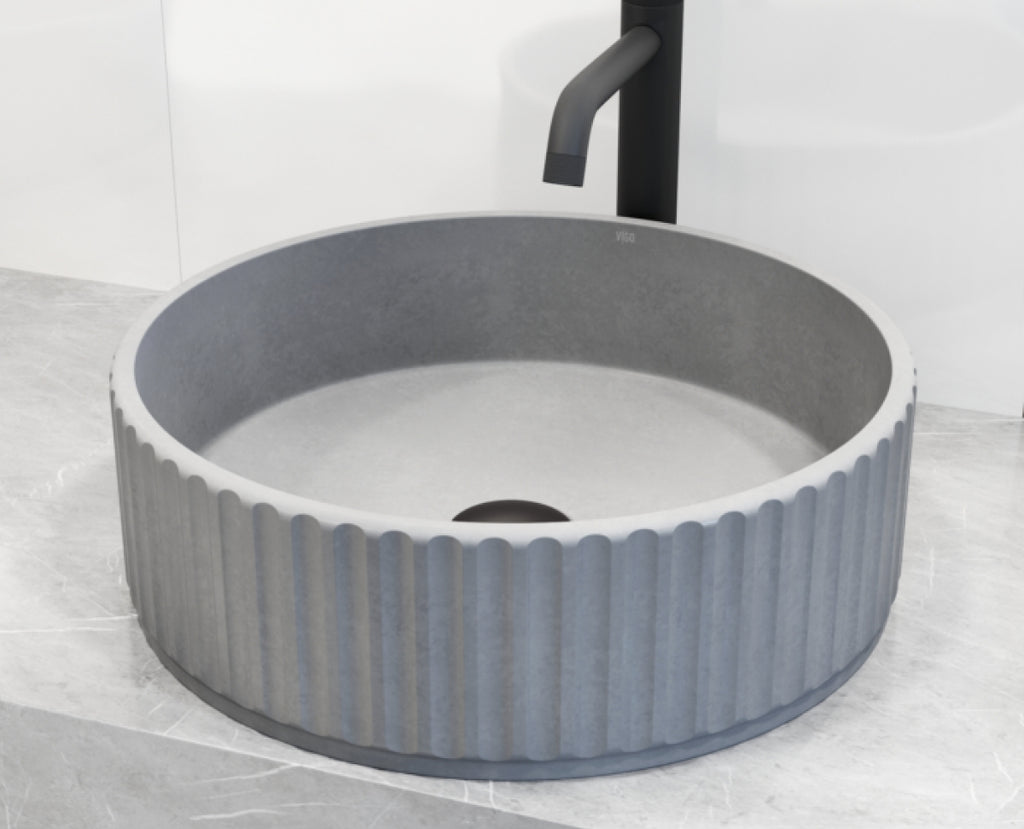 Concrete vessel sink with fluted edges.
