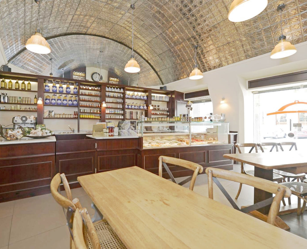 Dining room of a restaurant with curved ceilings and tin tile finishes.