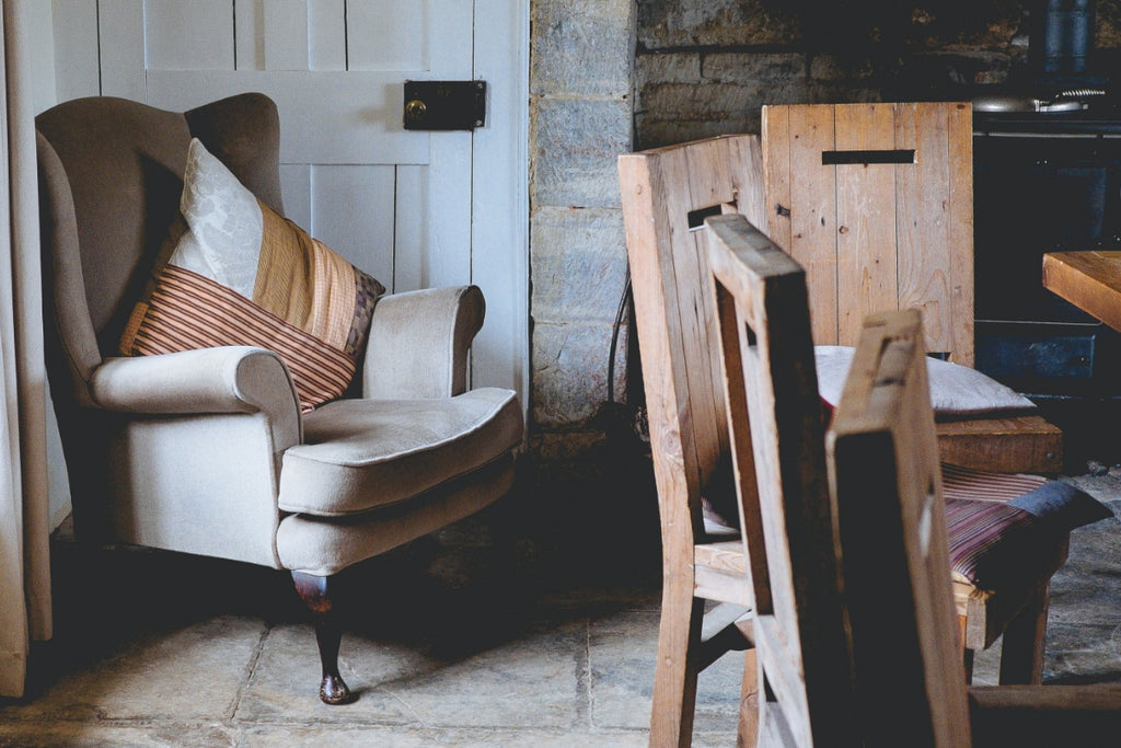 Corner of a dining room with a distressed floor.