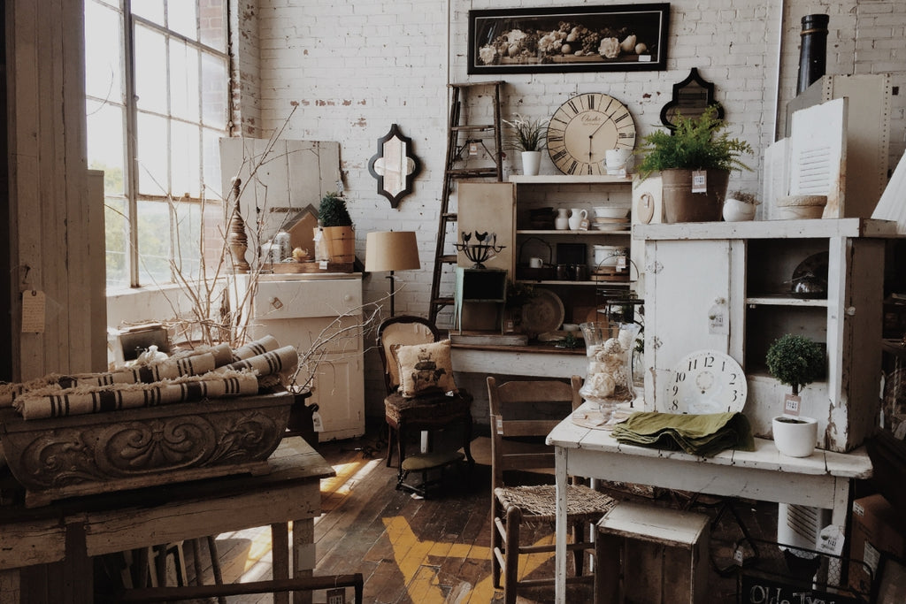 An eclectic styled room with lots of vintage and distressed accessories.