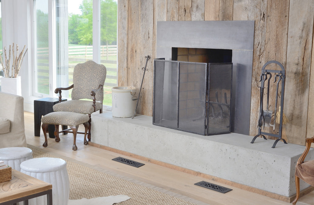 Fireplace with large hearth in a vintage styled living room.