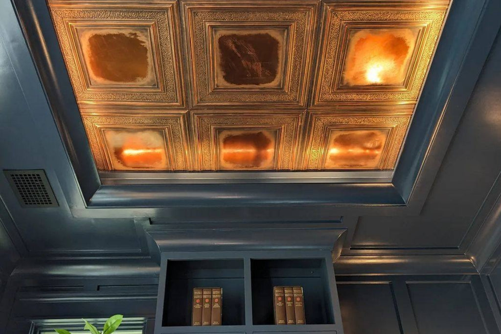 Tray ceiling with gold tin tile in a self-contained pattern.