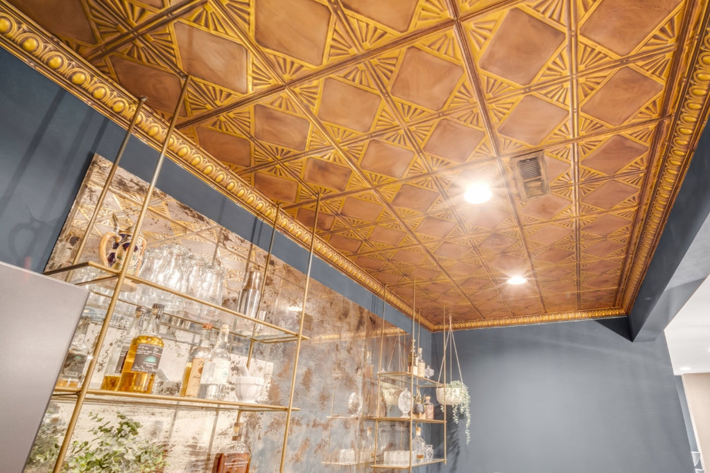 View of a kitchen looking up at a copper tin tile ceiling with a tessellating pattern.