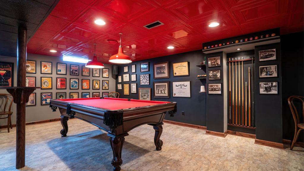 Game room with red tin tile on the ceiling and pool table in the foreground.