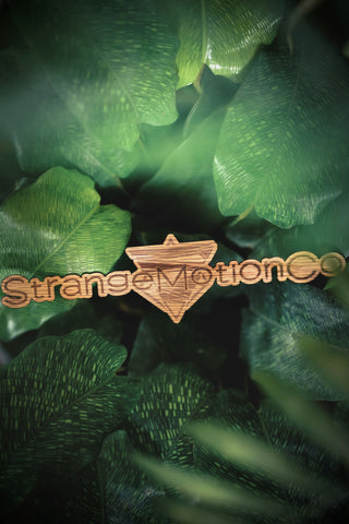 Close up of Strange Motion Co Logo created as a wooden sticker
