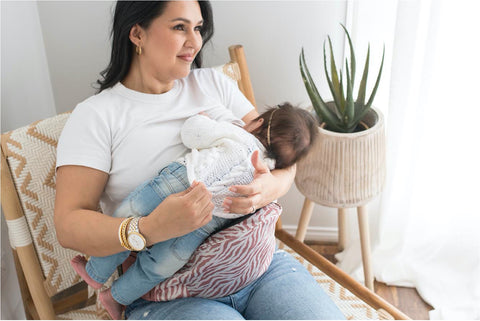 mum breastfeeds baby while sitting with hipsurfer hipseat baby carrier