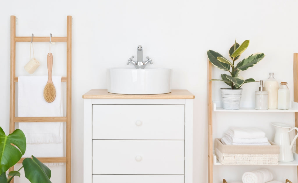 Remodeled bathroom in white and light wood.