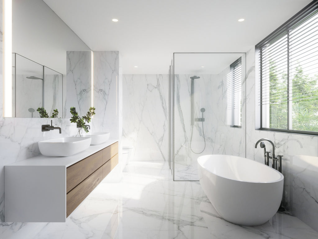 Large bathroom covered in marble with large windows and lots of light.