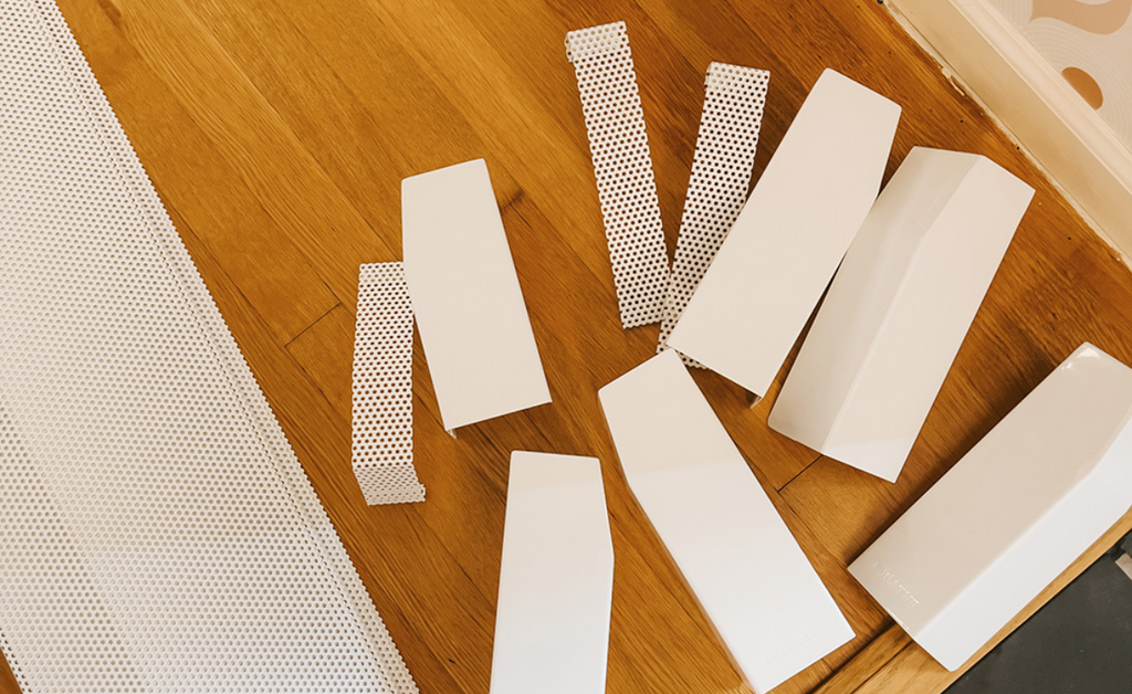 An assortment of baseboarders samples against an oak floor.