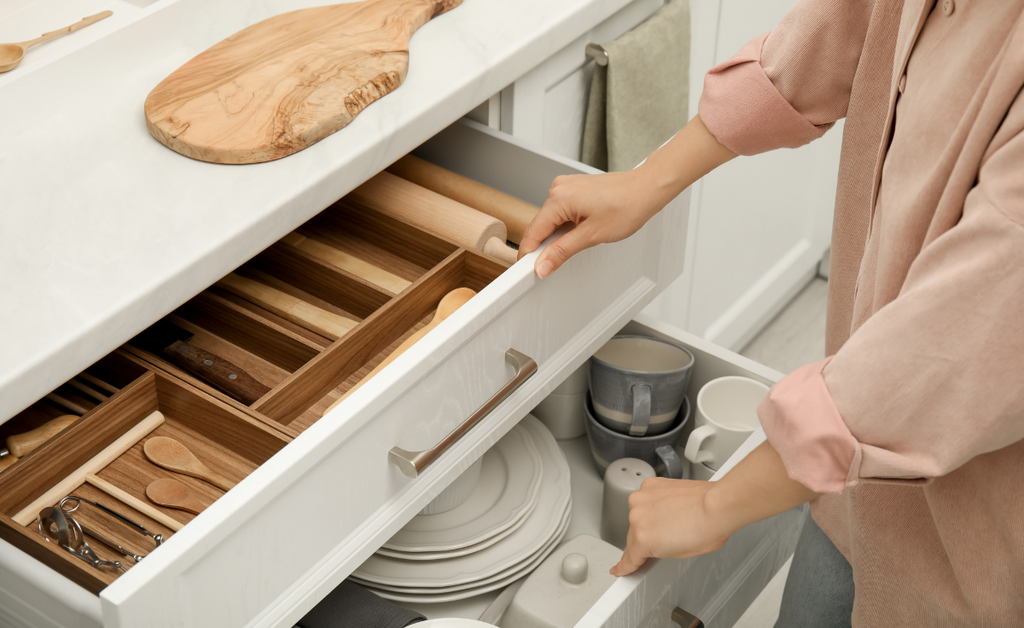Top down view of kitchen drawers with organizers for ultimate storage.