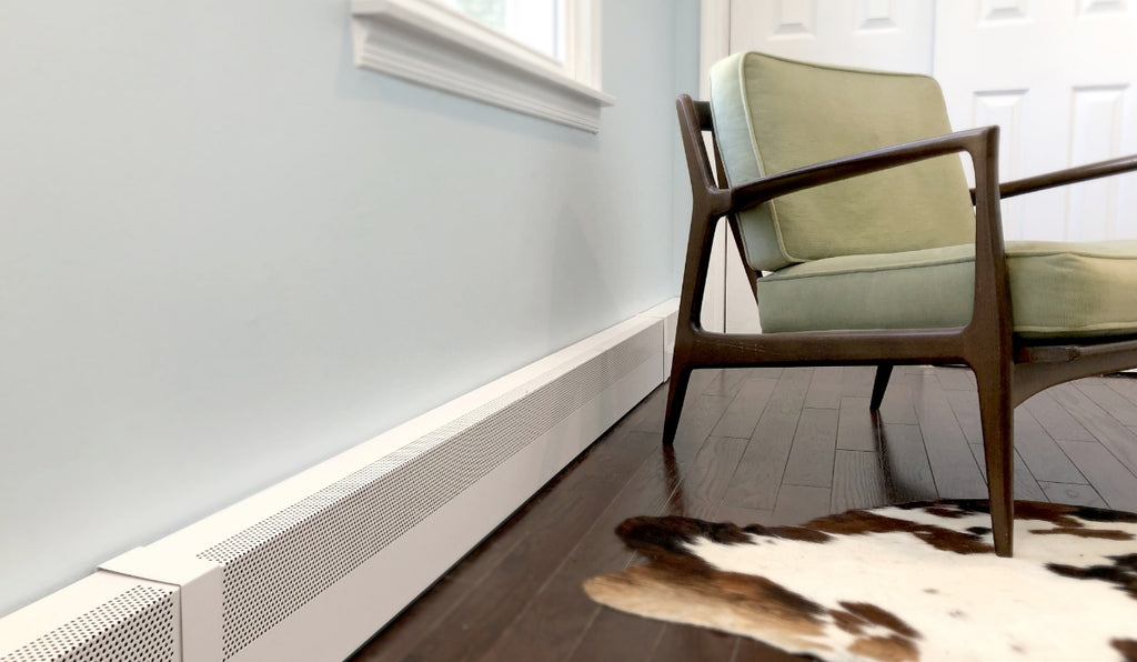 Small room with hardwood floors and animal print rug with white baseboard heaters along the wall.