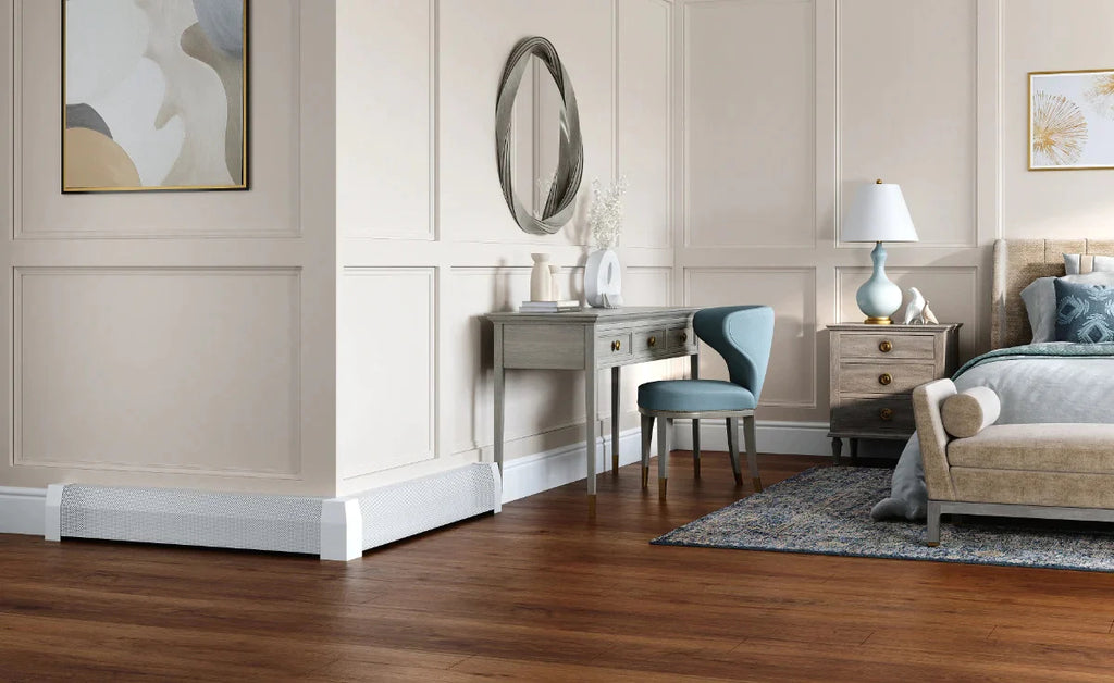 A large bedroom with dark wood floor and white walls with white hydronic baseboard heaters.