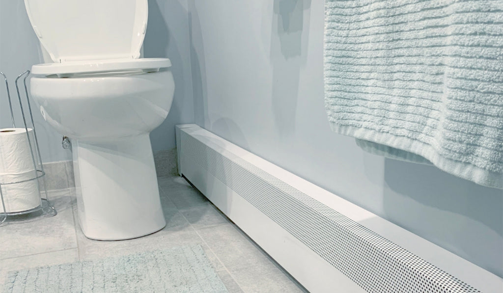 Light blue and white colors in a bathroom with a white baseboard heater. 