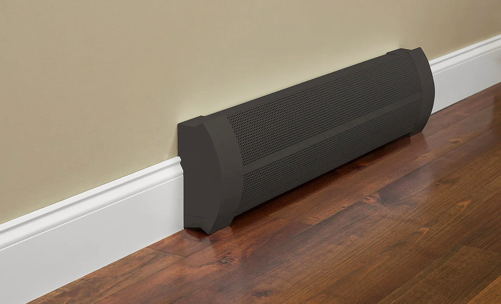 Elliptus style baseboard heater cover in oil rubbed bronze against a beige wall with white trim and wood floors.