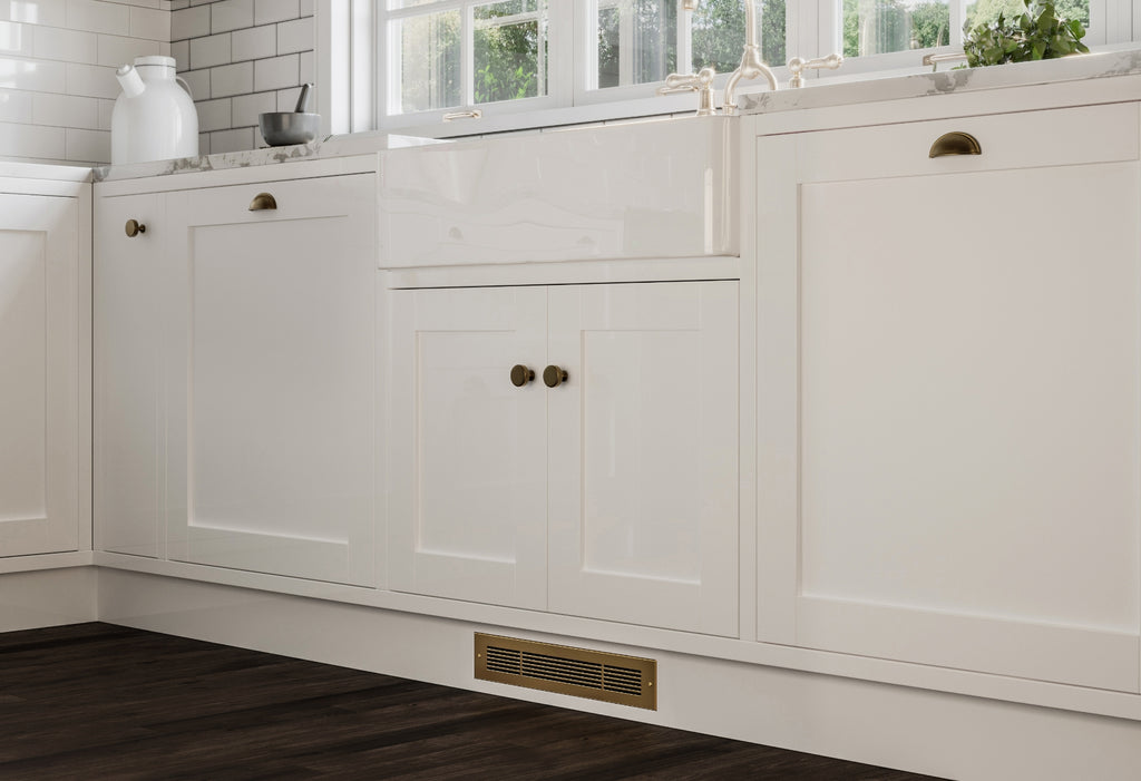 White kitchen with gold toe kick registers.