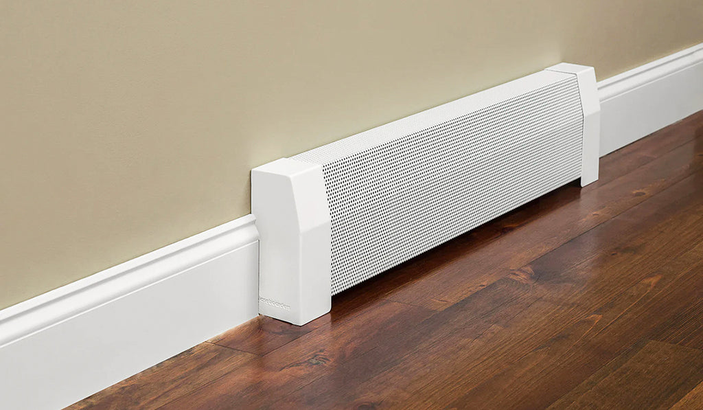 White steel baseboard heater cover against a beige wall, white baseboard, and dark wood floor.