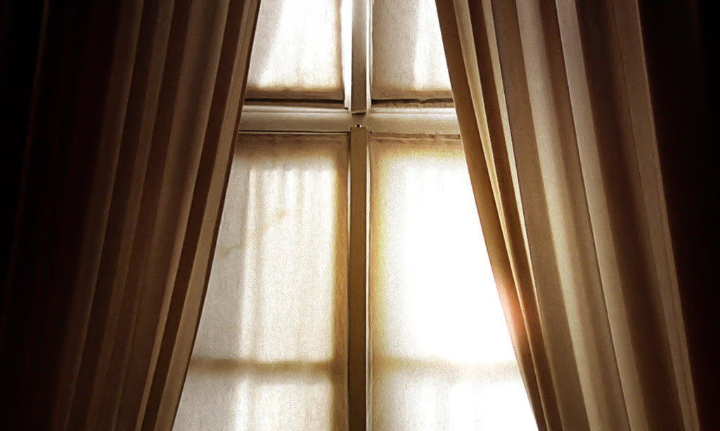 Thermal curtains in front of a window to keep the cold out.