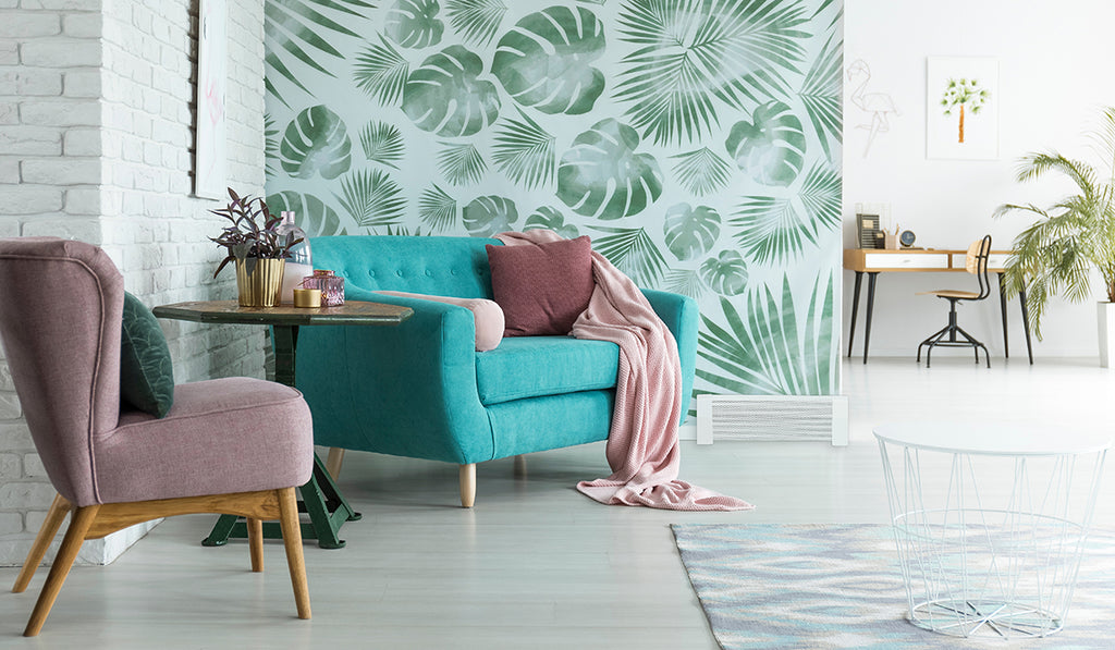 Tropical wallpaper on a living room wall with teal and mauve furnishings. 