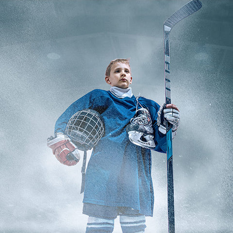 boy with hockey equipment