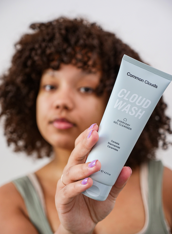Girl holding Cloud Wash gel cleanser face wash for acne-prone, sensitive skin