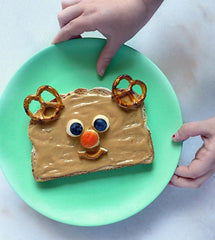 reindeer sandwhich for kids on a bamboo plate