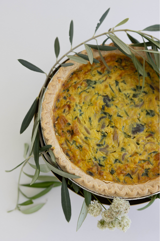 Golden gouda quiche with decor around it