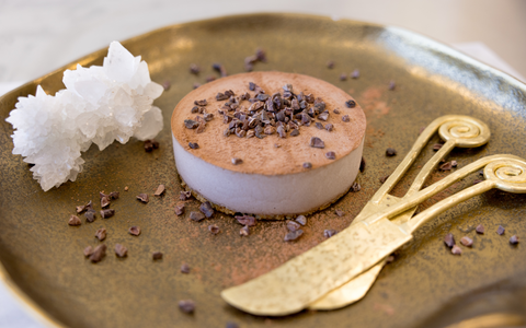 chocolate mousse cake, crystal and two brass cheese knives