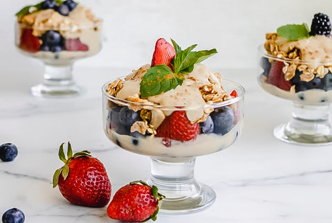 Berry parfait with cream cheese frosting served in glass